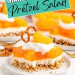 Slice of Orange Pretzel Salad with whipped topping, pretzel, and mandarin orange on a white plate.