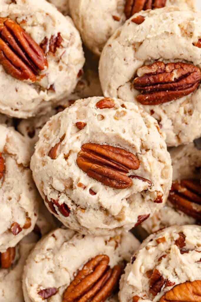 Close-up of butter pecan toffee cookies with whole pecan halves on top and a crumbly, nutty texture.