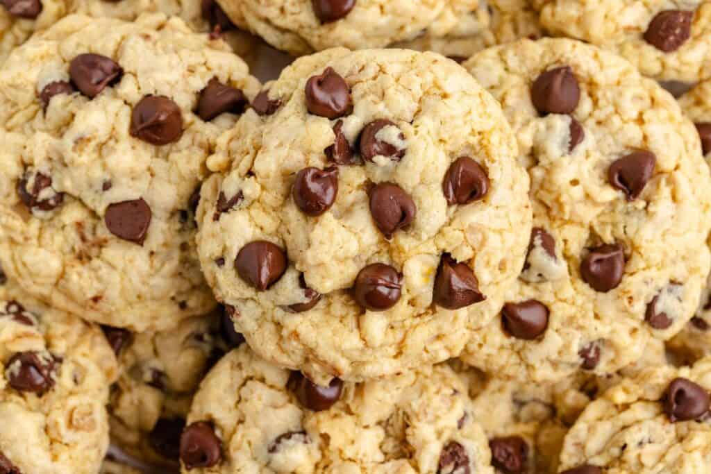 Close-up of stacked cake mix chocolate chip cookies, highlighting their texture and visible scattered chocolate chips.