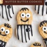 Nutter Butter cookies decorated with black and white icing to resemble referees, arranged together in a group.