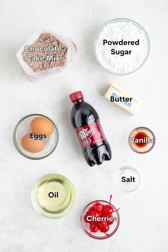 Dessert ingredients on countertop: chocolate cake mix, Dr. Pepper, cherries, butter, eggs, sugar, oil, vanilla.