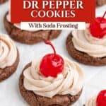 Chocolate cookies with soda frosting and cherries on parchment, text overlay: Dr Pepper Cookies with Soda Frosting.