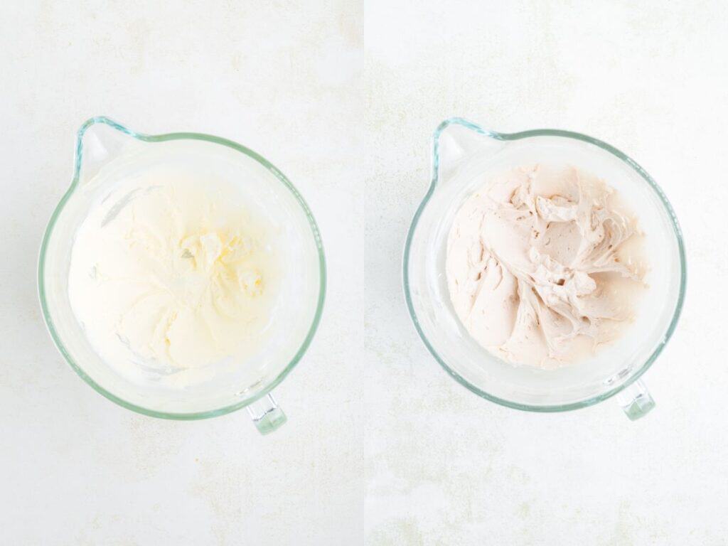 Two glass bowls with whipped frosting, one white and one light pink, side by side on a white surface.