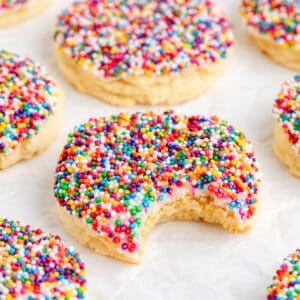 Dot Cake Cookies with cake mix and colorful sprinkles, surrounded by similar cookies on a white background.