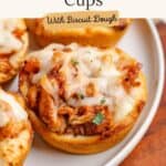 BBQ Chicken Cups with biscuit dough, cheese, and herbs on white plate; recipe name and button overlay.