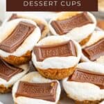 S’mores dessert cups on a plate, topped with toasted marshmallows and chocolate, labeled “S’mores Dessert Cups.”.