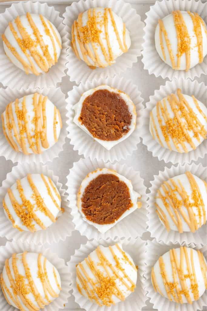 A grid of cookie butter-drizzled, crumb-topped white chocolate coated truffles.