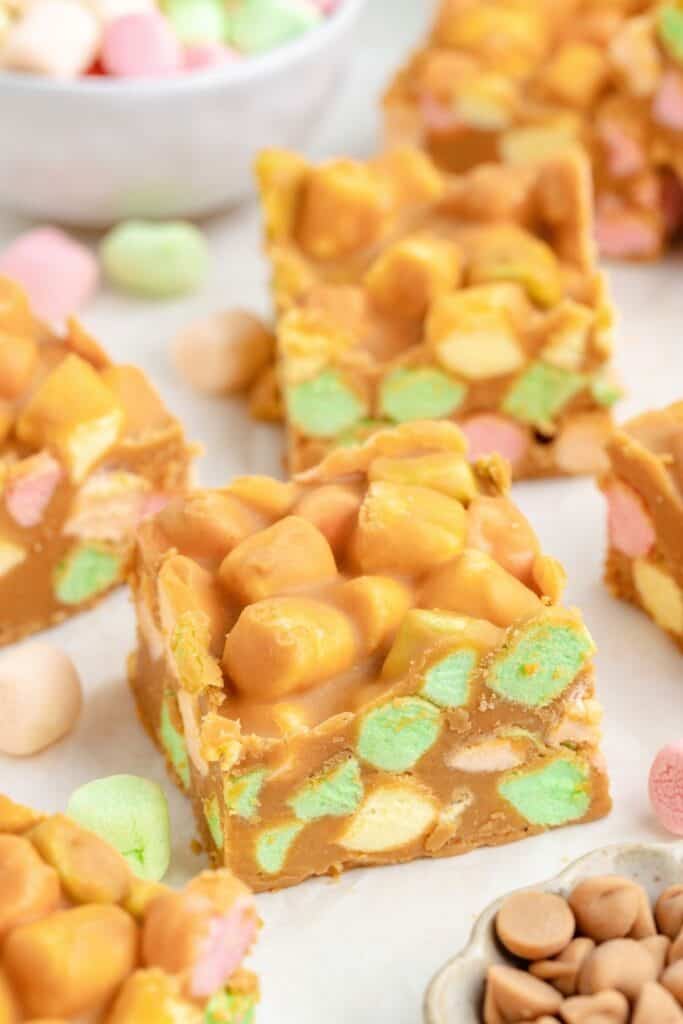 Peanut butter squares with marshmallows on a white background.